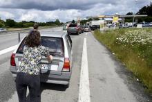 Pénurie de carburant femme poussant sa voiture 