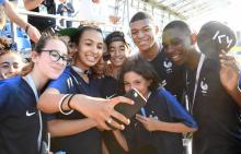 Des collégiens de Bondy, la ville où a grandi Kylian Mbappé, posent avec l'attaquant de l'équipe de France, à la fin d'un entraînement à Istra en Russie, le 27 juin 2018