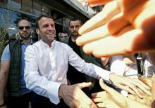 Le président Emmanuel Macron (C) salué par la foule dans les rues du Touquet (Pas-de-Calais), le 21 avril 2019